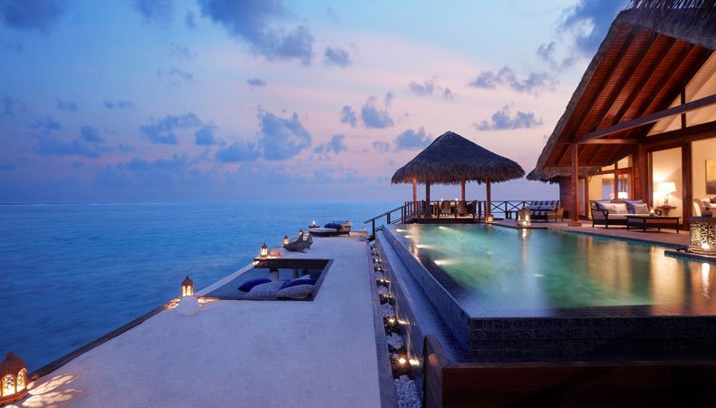 Luxury infinity pool with pavilion and sea view at dusk — symbol of the new tourism model