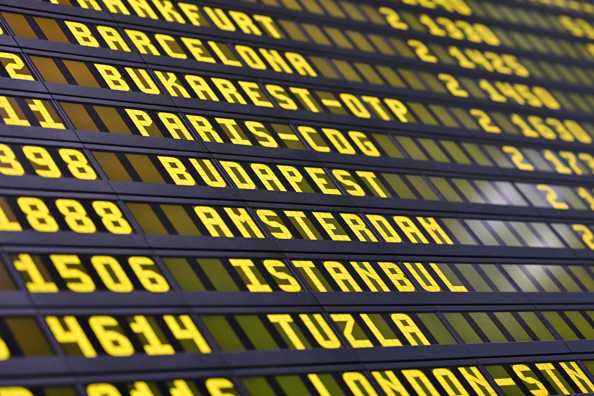 Airport departures board showing international destinations