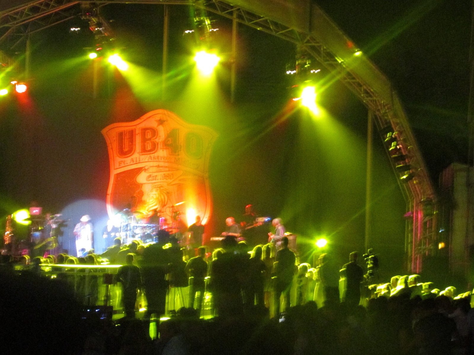 UB40 band performing live on stage with colorful lights